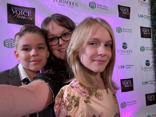 Kim Shappley and her two children, Kaleb, 10, and Kai, 11, at a fundraising event in Connecticut in September 2022. Shappley and her family left Texas this summer to protect Kai, who is transgender, from a climate she felt was hostile to trans kids, including a spate of anti-trans bills introduced by GOP legislators in recent years and Gov. Greg Abbott's directive ordering parents providing youths with gender affirming care to be investigated for child abuse.