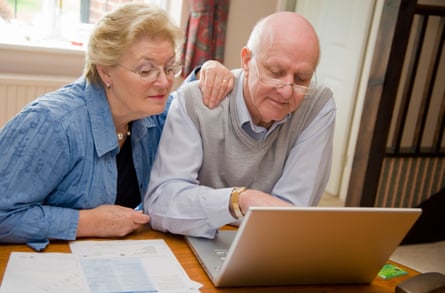 Mature senior couple using the internet on a laptop online