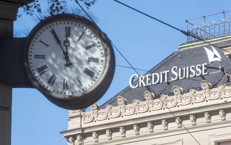 Credit Suisse pays down debt to calm investors