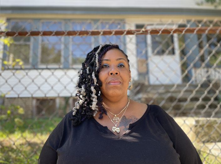Latasha Tatum, 40, stands outside the home she has lived in since childhood. The home went into foreclosure and has a new owner, leaving Tatum to be evicted from the property. (Photo by Natasha S. Alford/theGrio)
