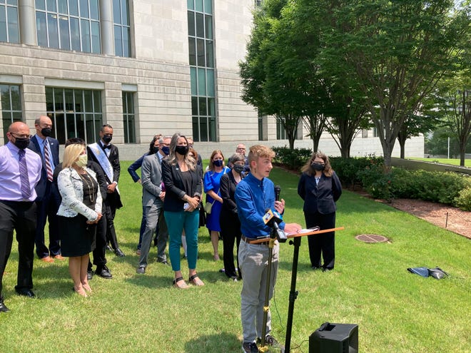 Dylan Brandt speaks at a news conference outside the federal courthouse in Little Rock, Ark., in July 2021. Brandt, a teenager, was among several transgender plaintiffs challenging a state law banning gender confirming care for trans minors. A federal trial was set to begin in October 2022 over the law's legality.