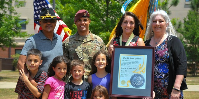 Army Capt. Gilberto De Leon poses for a photo with his family. De Leon was selected to promote to major in 2019, but his promotion packet stalled because of a misleading flag on his record.