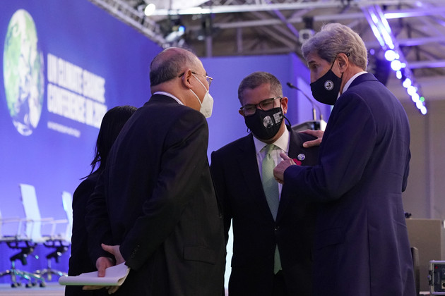 Xie Zhenhua talks with John Kerry during an event at the COP26 U.N. Climate Summit.