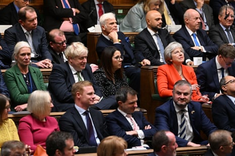 Boris Johnson and Theresa May sitting with fellow Conservative MPs listening to Jeremy Hunt deliver the autumn statement earlier.