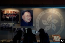 FILE - A portrait of former Chinese leader Deng Xiaoping is displayed at the exhibition "The Hong Kong Story" in the Hong Kong Museum of History, Oct. 16, 2020.