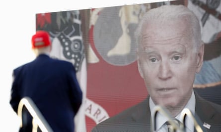 Joe Biden on a screen as Donald Trump holds a rally in Miami in November.