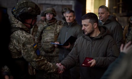 Volodymyr Zelenskiy awards a Ukrainian service member in the frontline town of Bakhmut.
