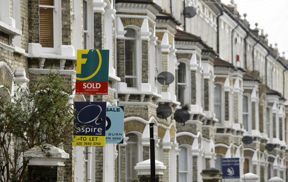 UK house prices: Estate agents&#39; boards are seen in south London