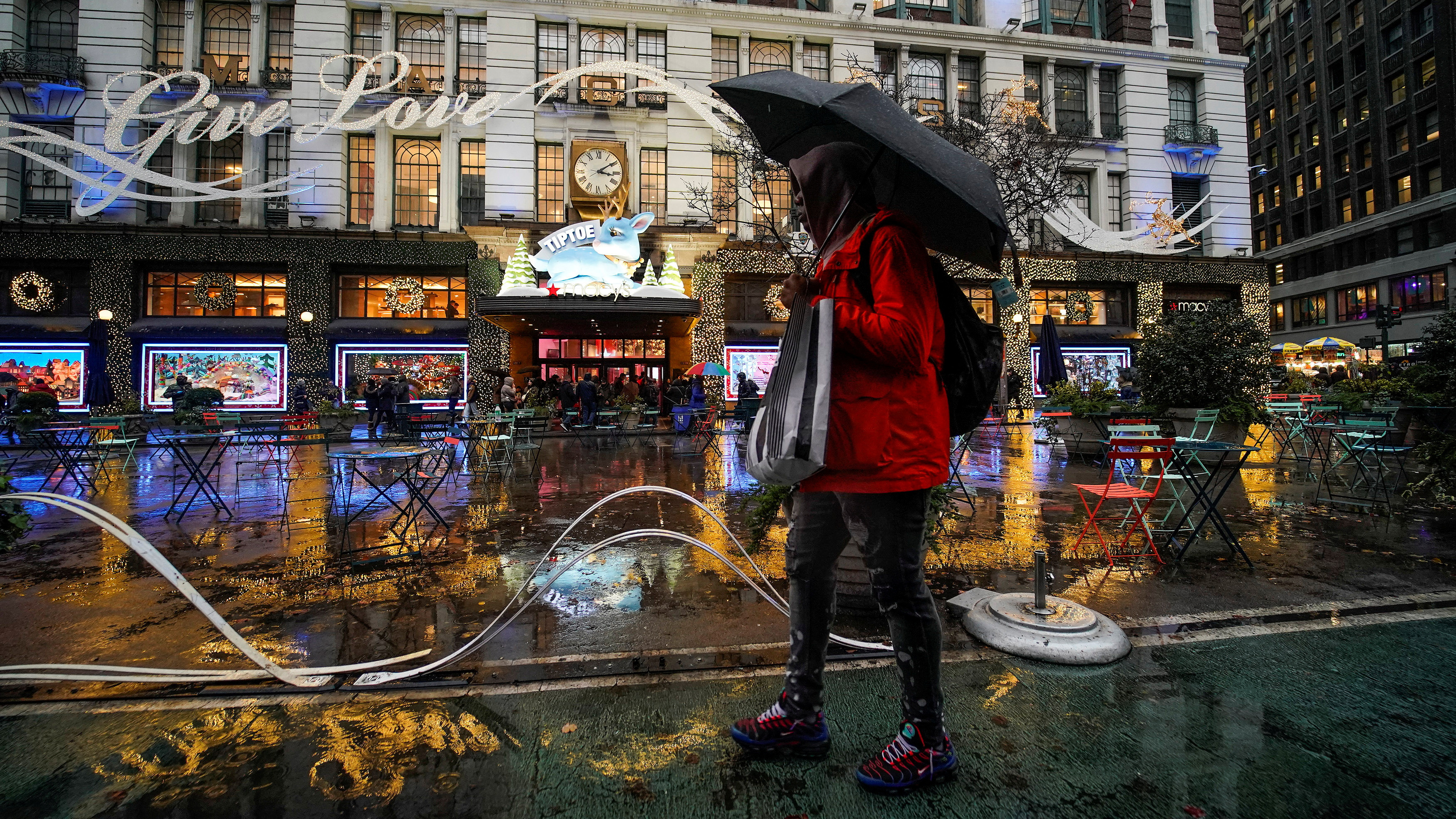 People carry shopping bags as they visit a department store during the holiday season in New York