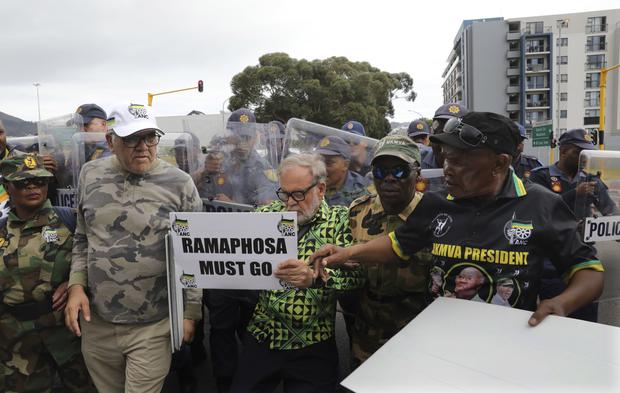 Anti-President Cyril Ramaphosa and expelled African National Congress member Carl Niehaus, centre, protests in Cape Town, South Africa on Tuesday (Nardus Engelbrecht/AP/PA)