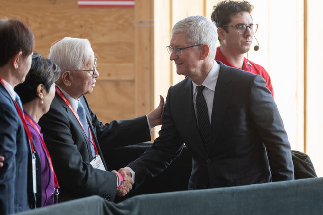Morris Chang, founder of Taiwan Semiconductor Manufacturing Co., greets Apple CEO Tim Cook on Dec. 6, 2022, in Phoenix.