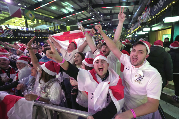 England fans wait for the start of the World Cup quarterfinal match between England and France at a fan zone in London.