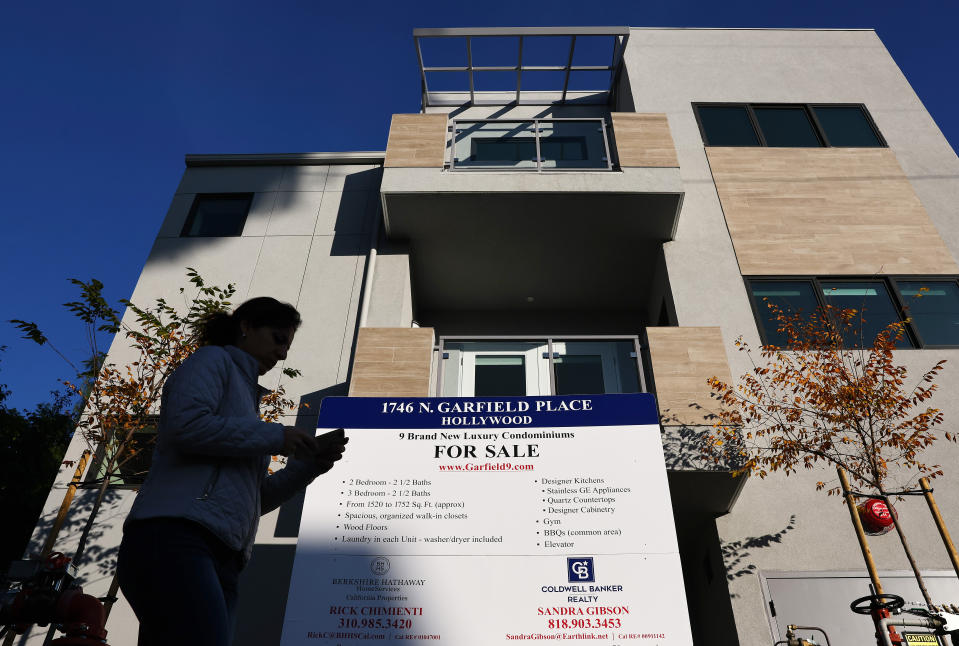 LOS ANGELES, CALIFORNIA - DECEMBER 19: A sign is posted in front of new condominiumsfor sale on December 19, 2022 in Los Angeles, California. The National Association of Realtors will release its November data on existing home sales later this week after October saw existing home sales decline 28 percent from one year earlier. (Photo by Mario Tama/Getty Images)