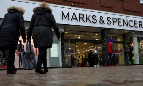 Shoppers walk past a branch of Marks and Spencer in Altrincham.