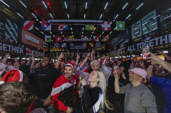 England fans watch the World Cup 2022 match between England and Senegal at Boxpark Croydon in London. Soccer fans helped the British economy by going out to watch the cup.