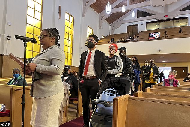 People are seen lining up to speak during a reparations task force meeting at Third Baptist Church in San Francisco in April