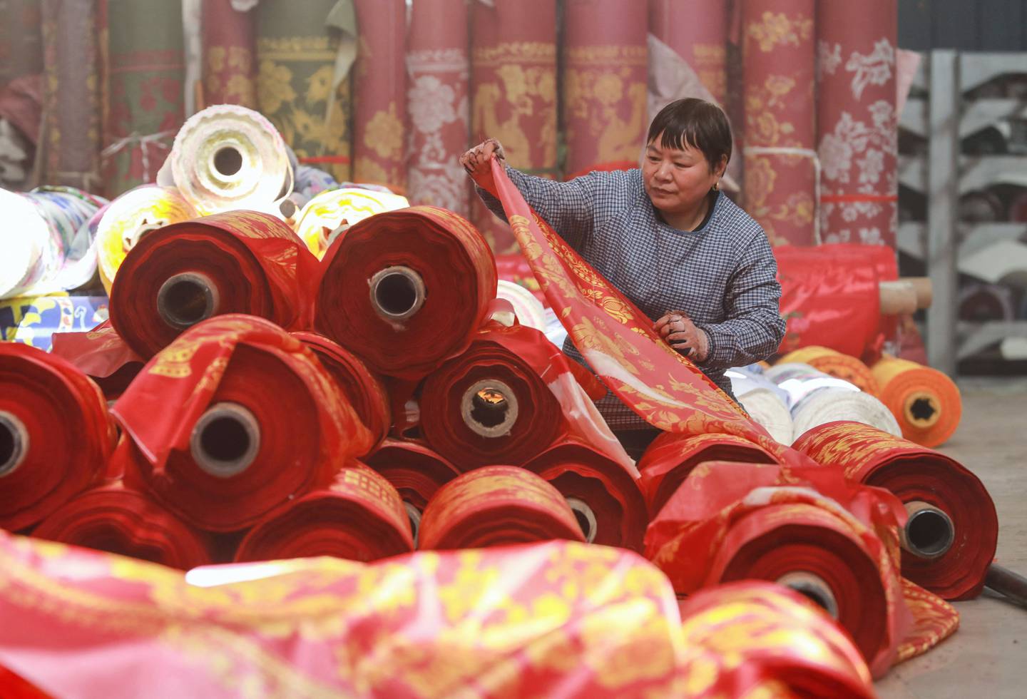 A worker checks cloth at a textile factory in Hangzhou in China's eastern Zhejiang province. Photo: AFP