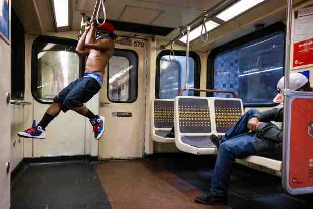 Frank does pull-ups as he rides the Metro B (Red)...