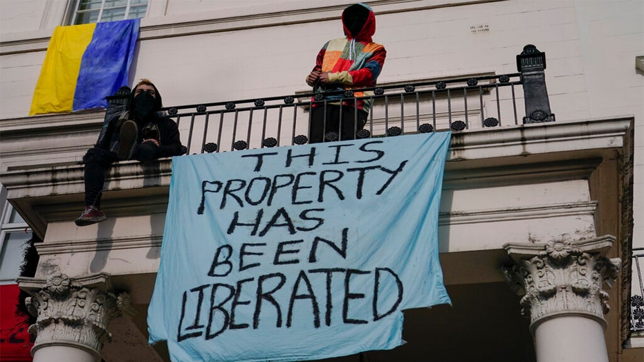 Pro-Ukraine protesters at a building reportedly owned by a Russian oligarch