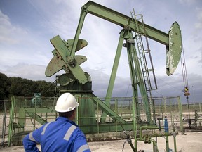 A production manager for Vermilion Energy Inc, watches an oil rig in France. European windfall tax on fossil fuels will continue to take a bite out of its profits over the next 12 months.