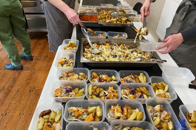 Food being dished out in preparation for freezing