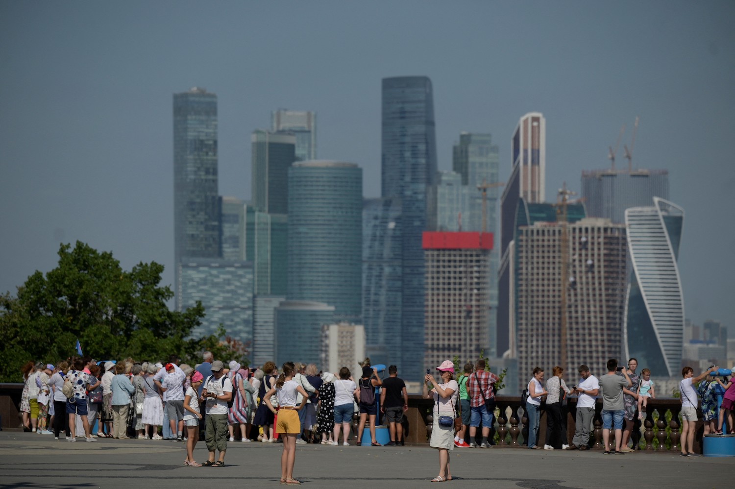 Visitors view the Moscow skyline from the Vorobyovy Hills observation point during a hot summer day in Moscow on Aug. 18.