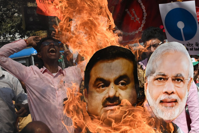 Cutouts of Narendra Modi and Gautam Adani are burnt during a rally in Kolkata on Feb. 6.Photographer: Dibyangshu Sarkar/AFP/Getty Images/Bloomberg