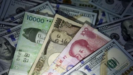 South Korean won, Chinese yuan and Japanese yen notes are seen on U.S. 100 dollar notes in this picture illustration taken in Seoul, South Korea, December 15, 2015. REUTERS/Kim Hong-Ji/File Photo