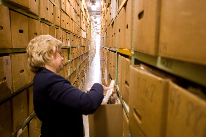 Deborah Hilton looks at some files housed in the stacks at the National Archives in 2007.