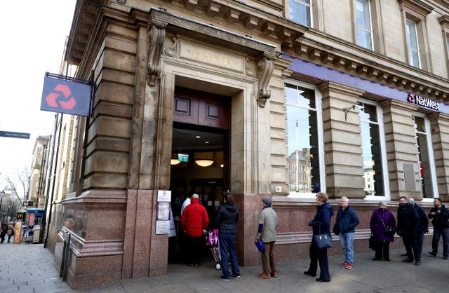 People queue outside a NatWest bank in Nottingham 