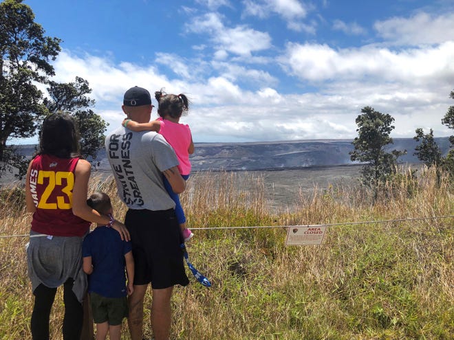 In this Saturday, Sept. 22, 2018, photo released by the National Park Service tourists visit Hawaii Volcanoes National Park on the first day the park reopened after volcanic activity forced the park to close for more than four months in Hawaii.