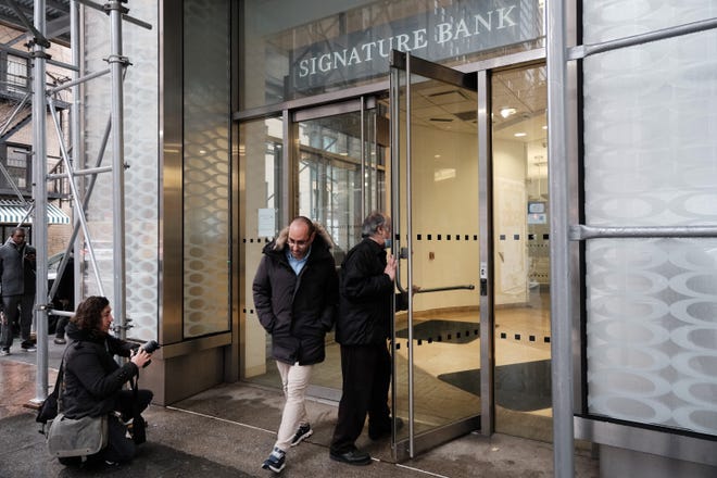 A man walks out of a Manhattan branch of Signature Bank which was closed by bank regulators on Sunday on March 13, 2023 in New York City. The move by the state's Department of Financial Services seeks to prevent a banking crisis spurred by the failure of Silicon Valley Bank.