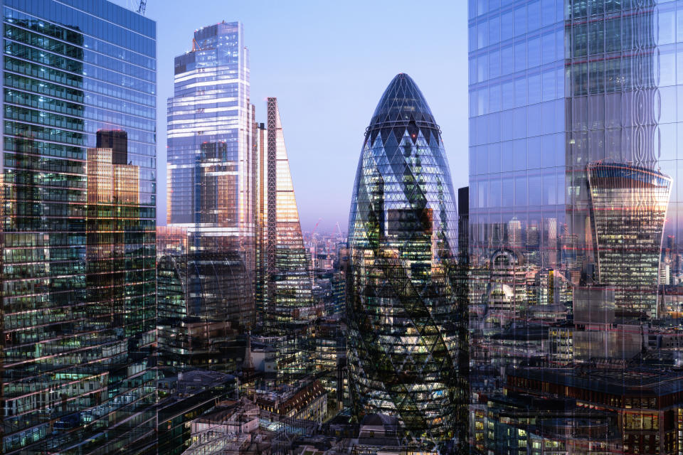 crypto UK, London, multiple exposure, elevated view of high rise financial buildings in the city, illuminated at dusk