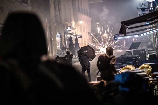 Protesters clash with police officers on the sidelines of a demonstration, a few days after the French government pushed a pensions reform through parliament without a vote, using article 49.3 of the constitution, in Nantes, western France, on March 21, 2023.