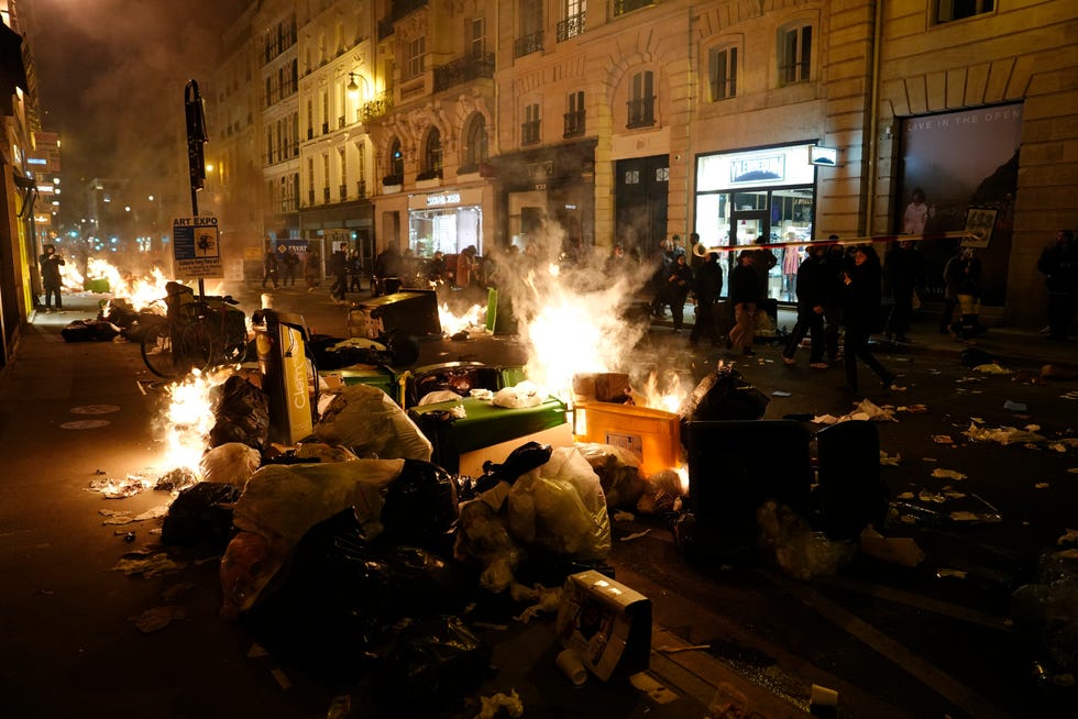 Piles of uncollected garbage is set on fire by protesters after a demonstration near Concorde square, in Paris, March 16, 2023. (AP Photo/Lewis Joly, File)
