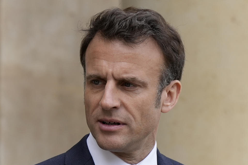 French President Emmanuel Macron looks on as he talks with Senegalese war veterans Friday, April 14, 2023 at the Elysee Palace in Paris. Some of the last survivors in France from a colonial-era infantry corps that recruited tens of thousands of African soldiers to fight in French wars around the world will be able to live out their final days with family members back in Africa after a French government U-turn earlier this year on their pension rights. (AP Photo/Lewis Joly, Pool)