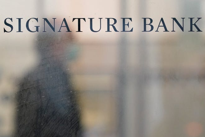 A sign is displayed at a branch of Signature Bank in New York, on March 13, 2023. Leaders of the Senate's banking committee on March 23 warned former chief executive officers at Silicon Valley Bank and Signature Bank that they expect them to testify before the panel, saying in a letter to each: “you must answer for the bank's downfall.”