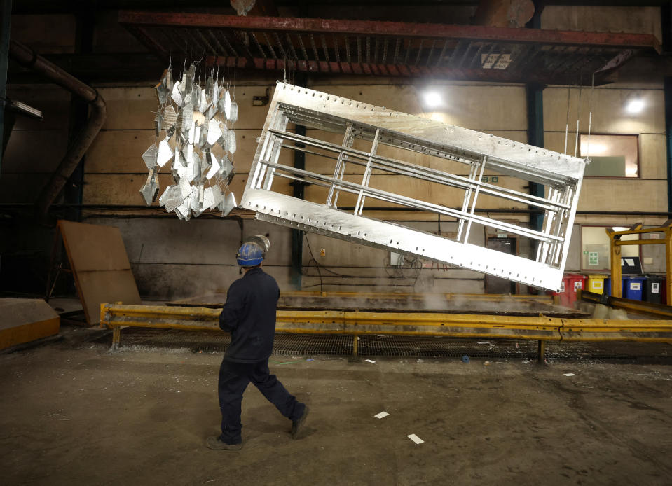 manufacturing  A worker walks past freshly galvanised pieces of metal inside the factory of Corbetts The Galvanizers in Telford, Britain, June 28, 2022. REUTERS/Phil Noble