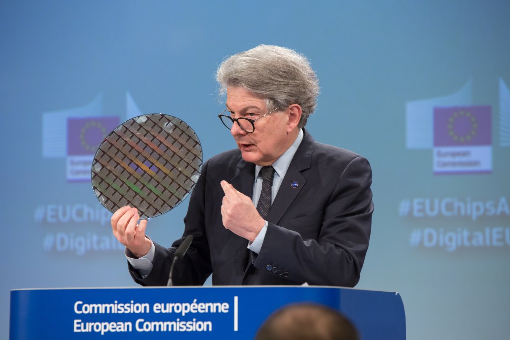 Photo: European Commissioner Thierry Breton at the podium holding a chip wafer. Credit: Aurore Martignoni/European Commission