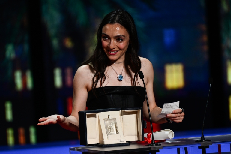 Turkish actress Merve Dizdar delivers a speech on stage after she was awarded with the Best Actress Prize for her part in the film 