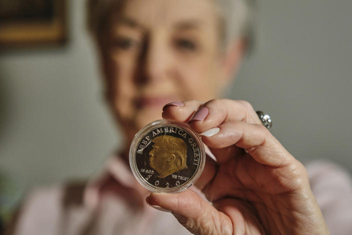 An Alabama grandmother holds one of the coins she purchased online in her apartment in Mobile, Ala., on May 19. (Dan Anderson for NBC News)