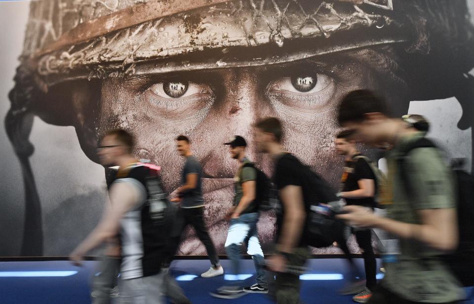 FILE - Visitors passing an advertisement for the video game &#39;Call of Duty&#39; at the Gamescom fair for computer games in Cologne, Germany, on Aug. 22, 2017. The European Union on Monday approved Microsoft&#x002019;s $69 billion purchase of video game maker Activision Blizzard, deciding the deal won&#x002019;t stifle competition for popular console titles like Call of Duty and accepting the U.S. tech company&#x002019;s remedies to boost competition in cloud gaming. (AP Photo/Martin Meissner, File)