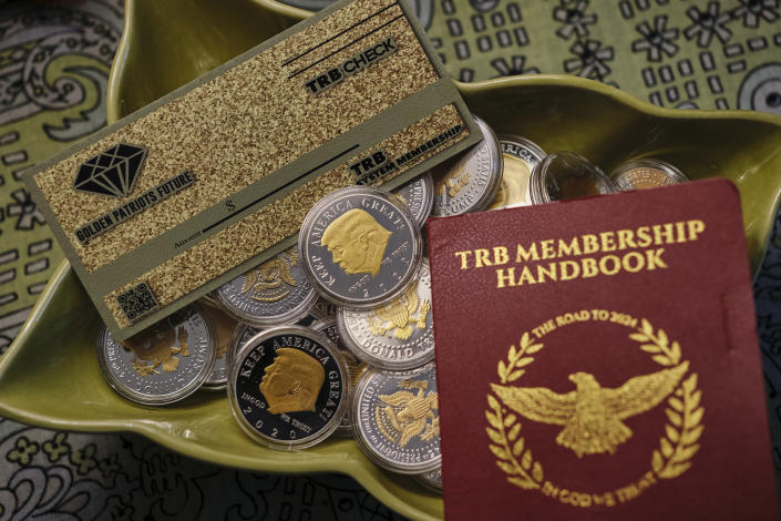 A booklet, check and collection of coins bought by an Alabama grandmother when she invested $1500 in &#x00201c;Trump Bucks.&#x00201d;  (Dan Anderson for NBC News)