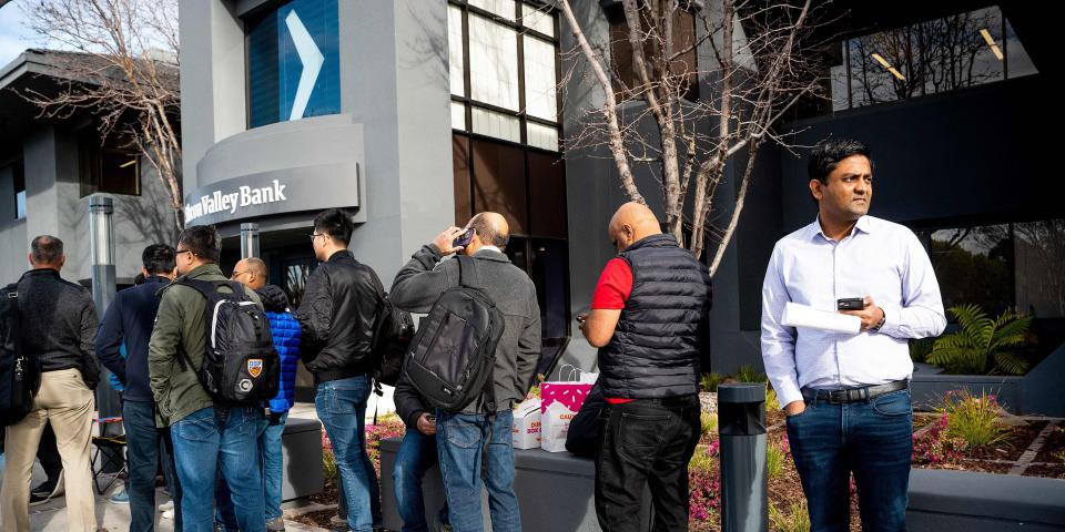 Silicon Valley Bank customers wait in line at SVBs headquarters in Santa Clara, California on March 13, 2023.