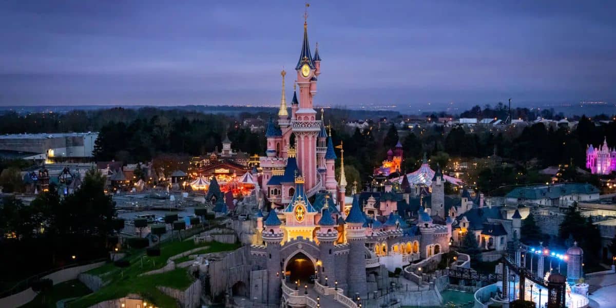 Disneyland Paris' Sleeping Beauty Castle lights up at dusk