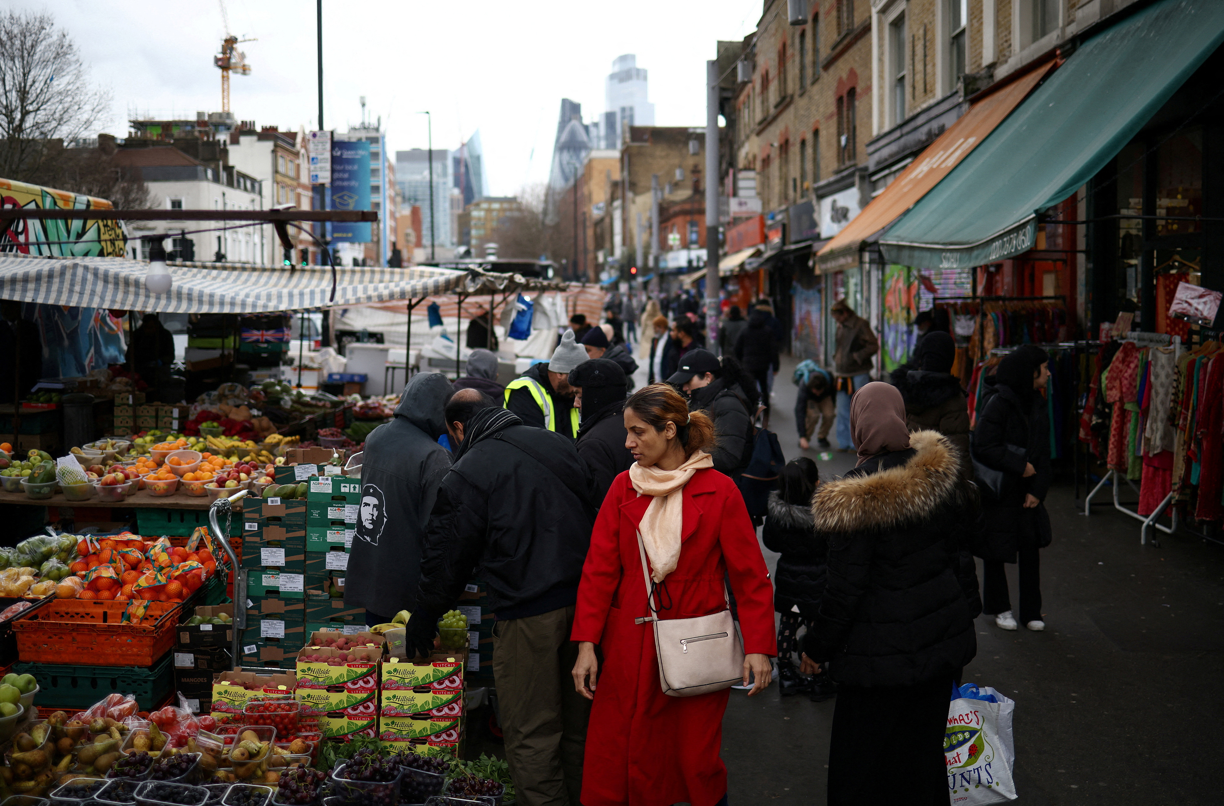 People browse stalls at a street market in east London