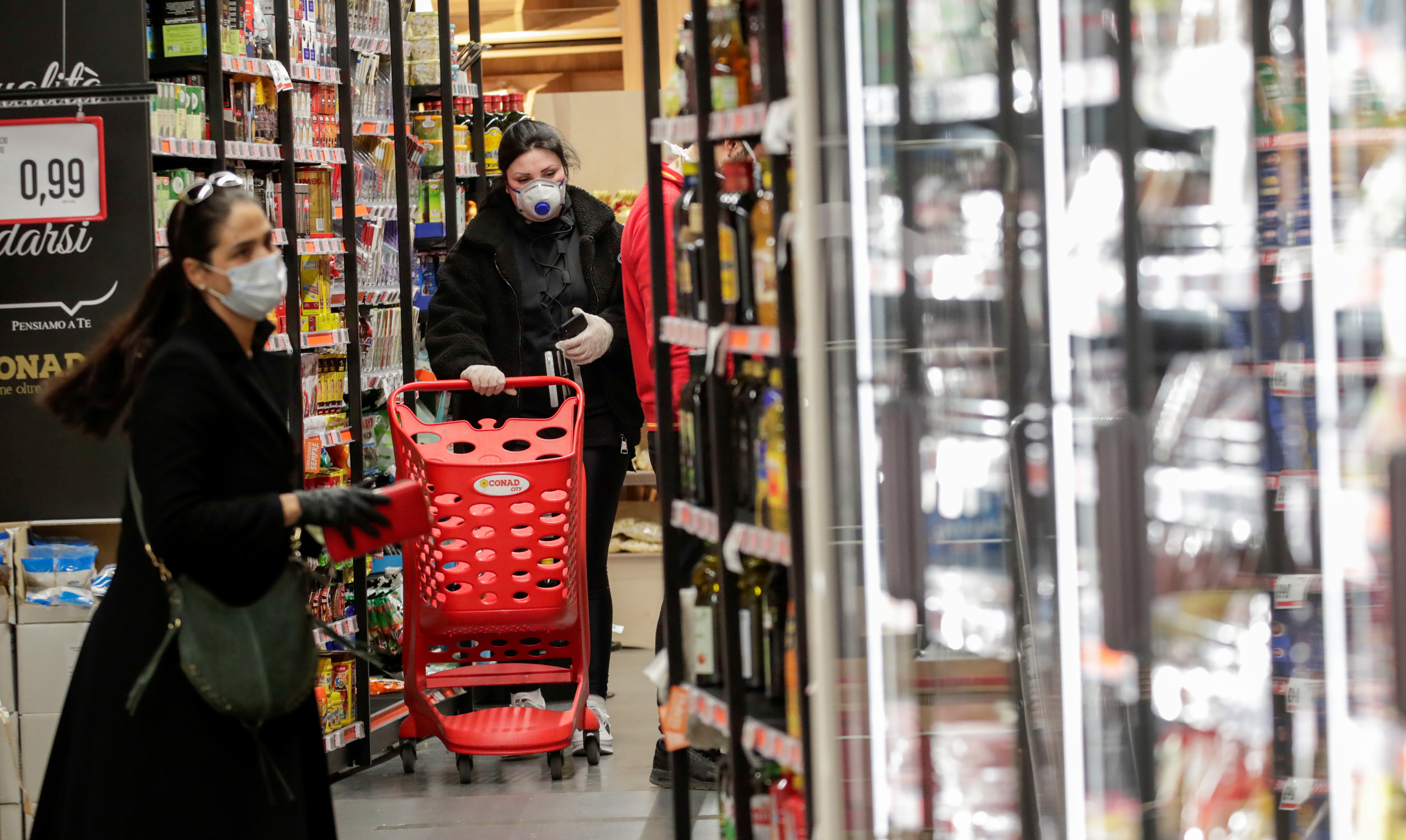 People wearing protective face masks are seen in a supermarket in Posillipo