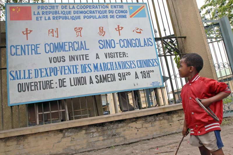 A Congolese boy looks up toward a sign advertising a commercial center selling Chinese products in Kinshasa, Democratic Republic of the Congo, on Nov. 3, 2006.