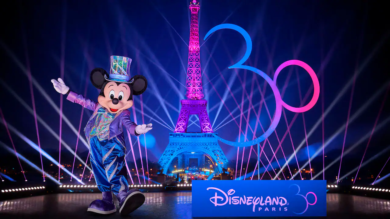 Mickey Mouse posing in his Disneyland Paris 30th anniversary outfit in front of the Eiffel Tower