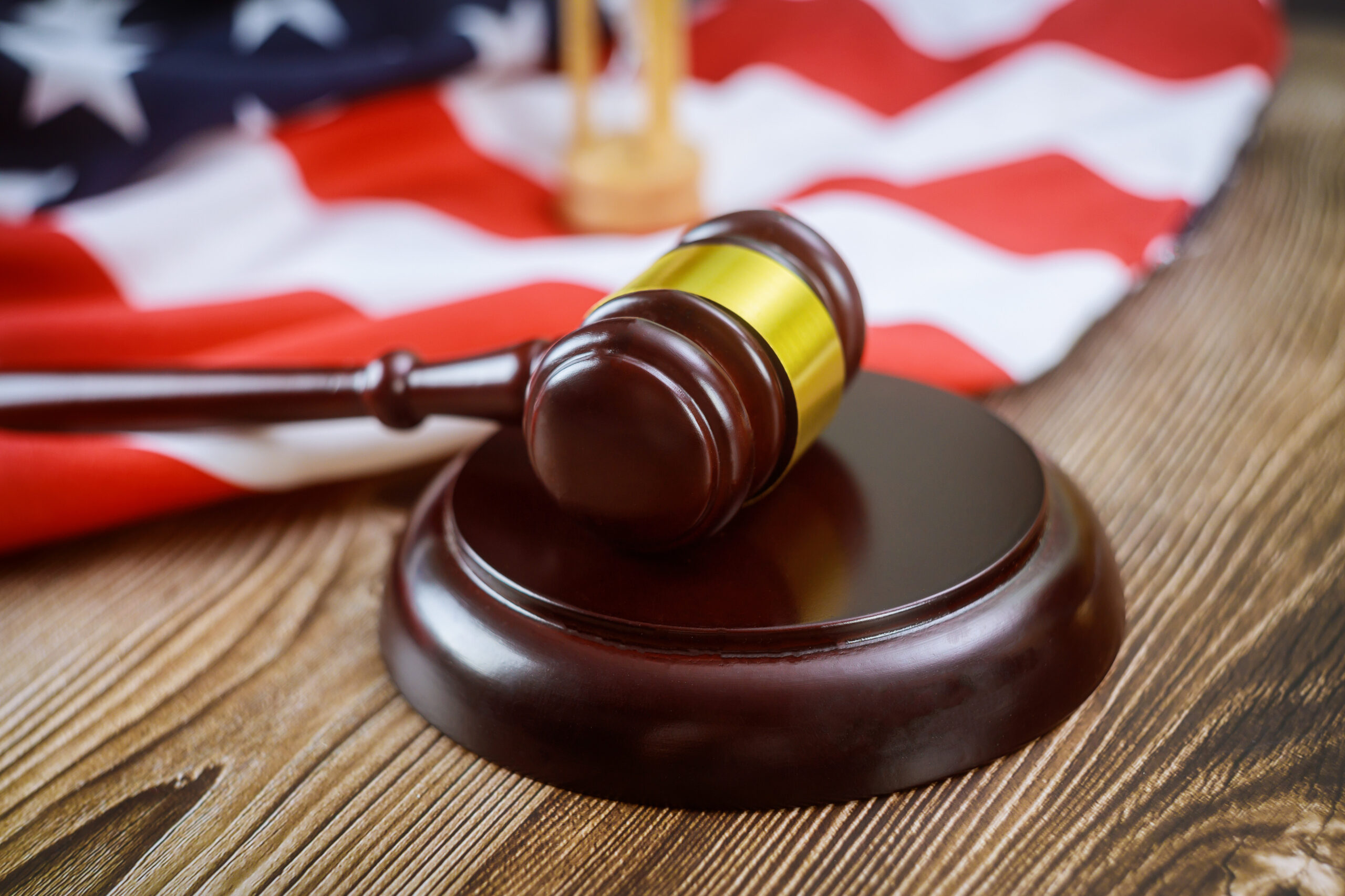 US Flag And Judges Gavel In A Courtroom